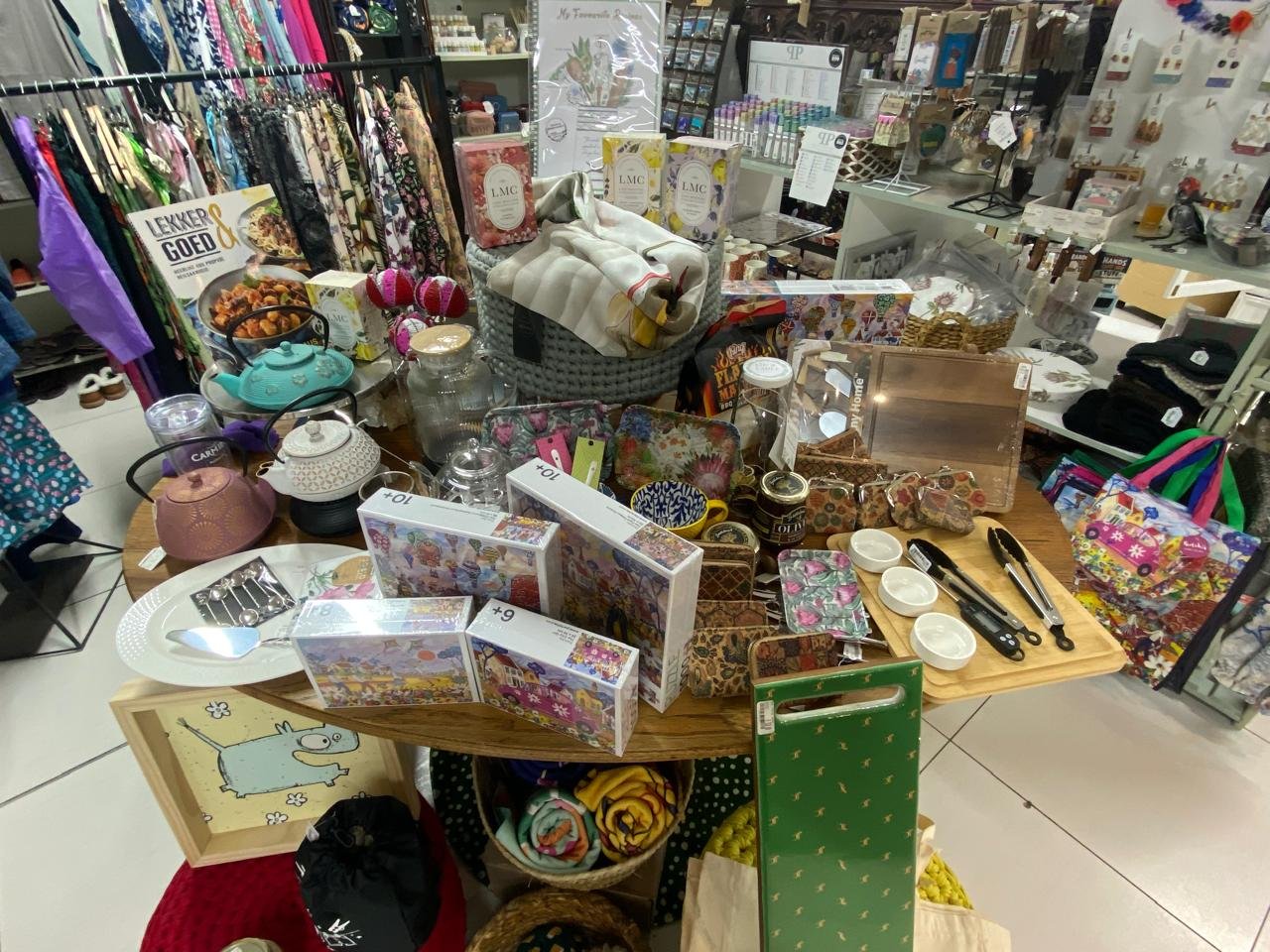 The centre gift table laid with teapots, puzzles, boards and tins