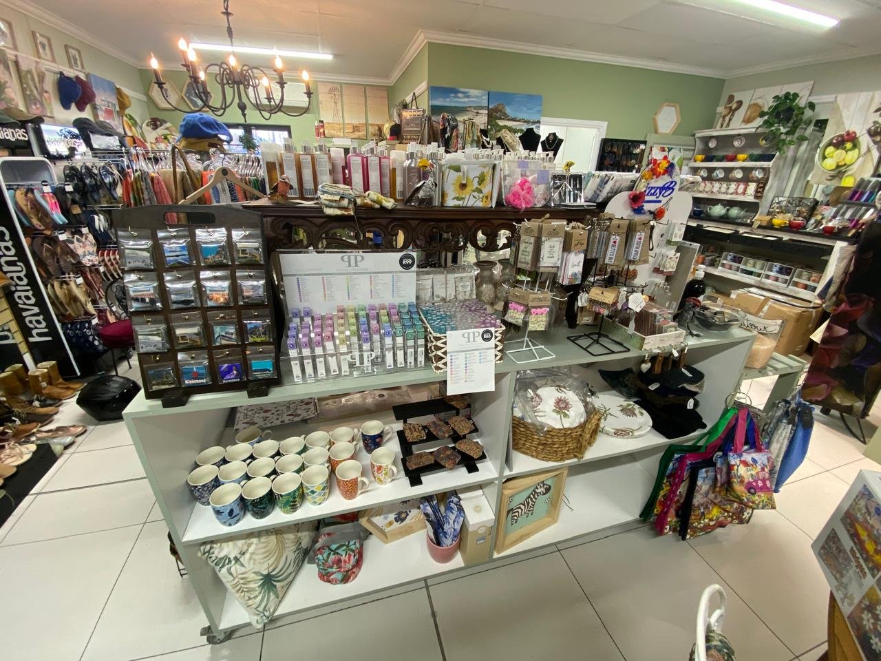 Inside Mooi @Albertyn — display tables of mugs and gifts, clothing rails and the jewellery counter