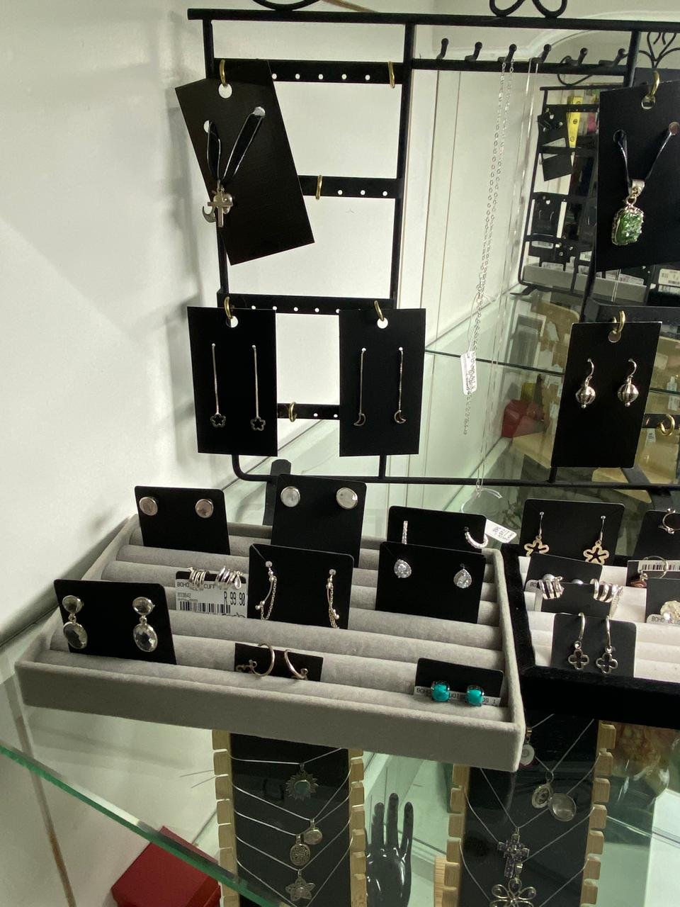 Sterling silver studs, hoops and pendants in the glass cabinet