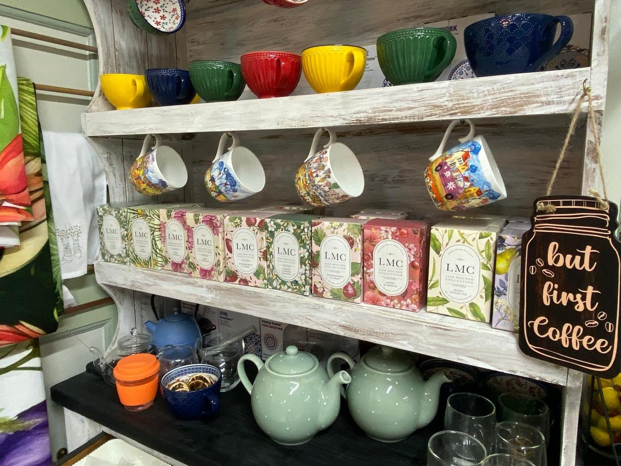 A painted dresser holding LMC teas, colour mugs and teapots